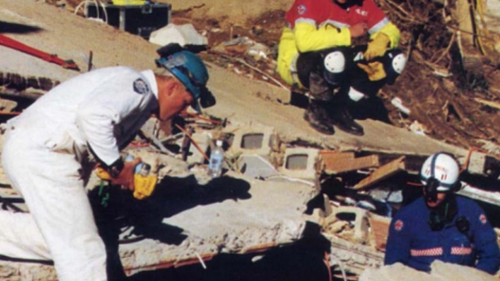 AFP Rescue team member Peter Davis is seen here positioned ready to assist with the successful extraction of Stuart Diver from the rubble of the landslide. Photo courtesy of Mick Travers.