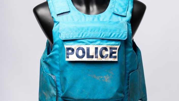 Blue woven fabric padded vest with front pocket and large white label that reads 'POLICE' in large black block letters (AFPM8869)