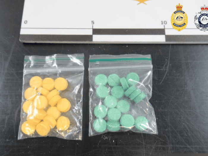 Yellow and green pills in plastic bags