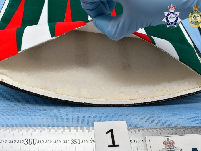 Tests revealed a backgammon game had false compartments that contained packages of white crystals, totalling 991.6g of methamphetamine. 