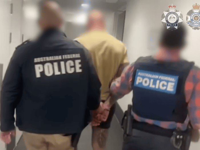 officers with arrested offender