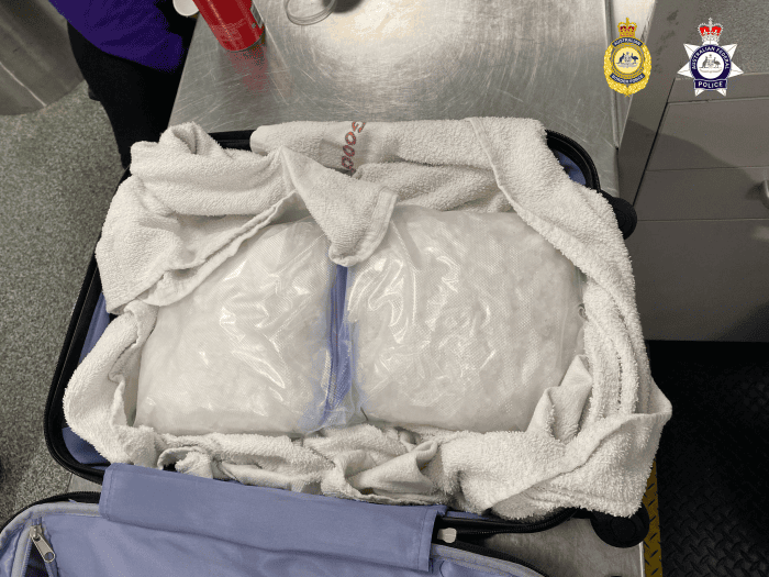 A picture of suspected methamphetamine wrapped in a towel within a suitcase 