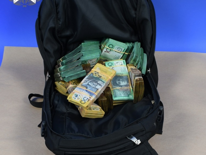 A picture of a knapsack with a large amount of cash in it