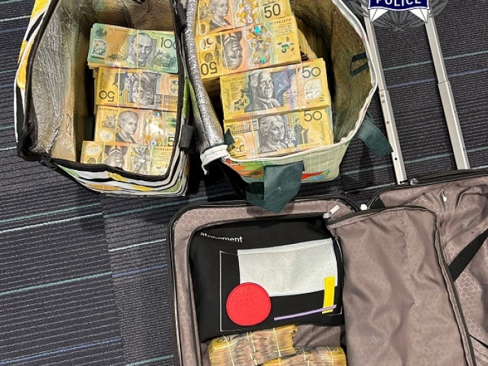 Bundles of $50 notes in two suitcases