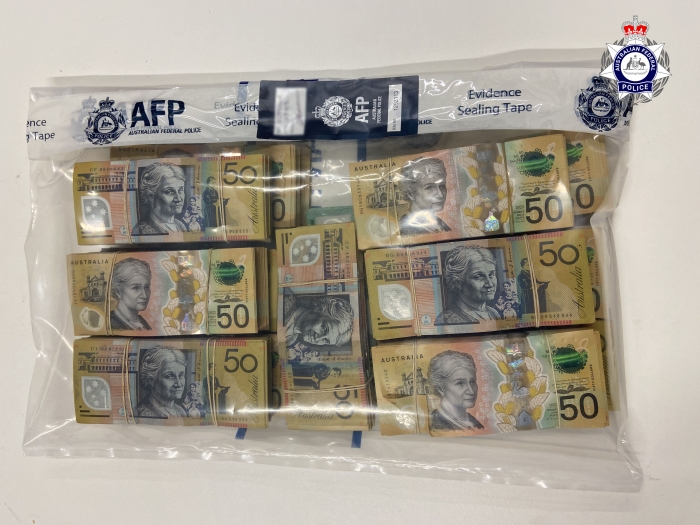 Bundles of $50 notes in a clear AFP branded evidence bag 