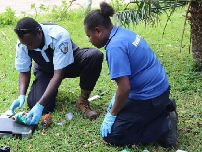 Twp Vanuatu police officers inspecteing items