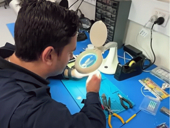 A person look at tools through a magnifying glass