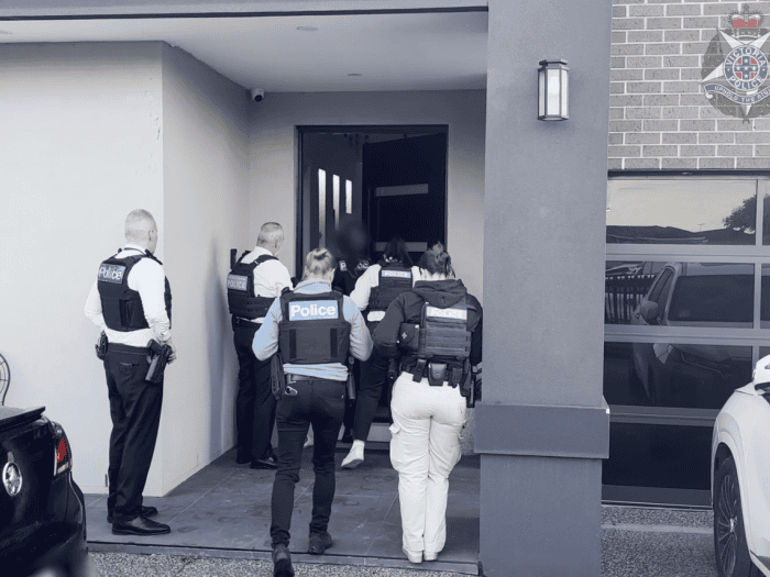 Officers attend a home in Meadow Heights in relation to the Adass Israel Synagogue arson attack