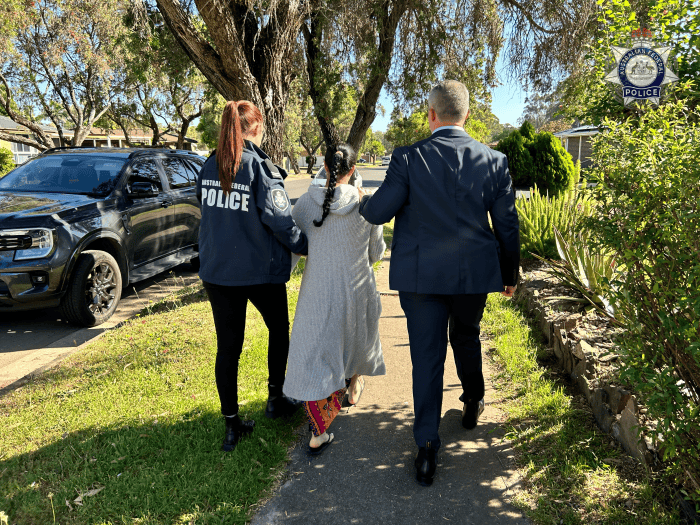 AFP officers arresting the Sydney woman
