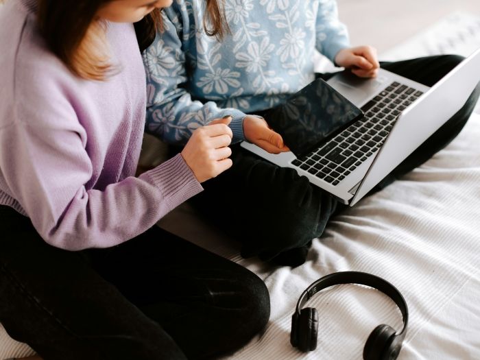 Adult helping child with devices