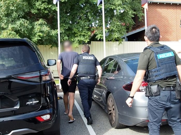 Image of a WA man jailed for cyber offences being arrested by AFP investigators 