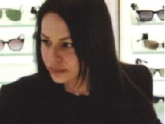 The woman is described as being of Middle Eastern appearance, with long brown hair and speaking with a lisp.