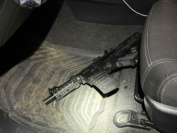 a gel blaster on the floor of a car