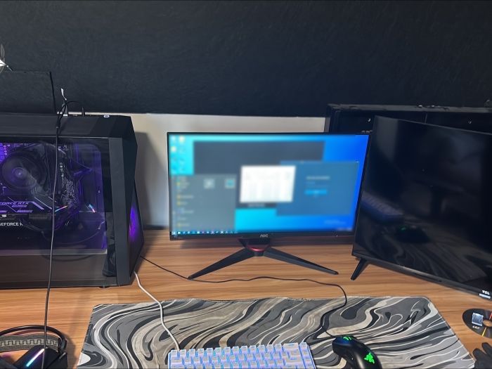 A computer set up on a wooden desk 