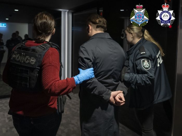 AFP officers arresting a man in Melbourne in relation to Operation Parkes 