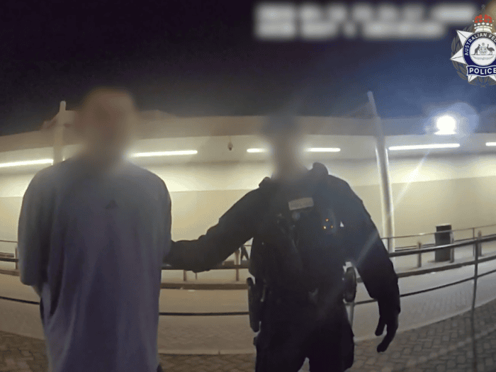 AFP officer with a NSW man in custody following an incident on a flight to Perth