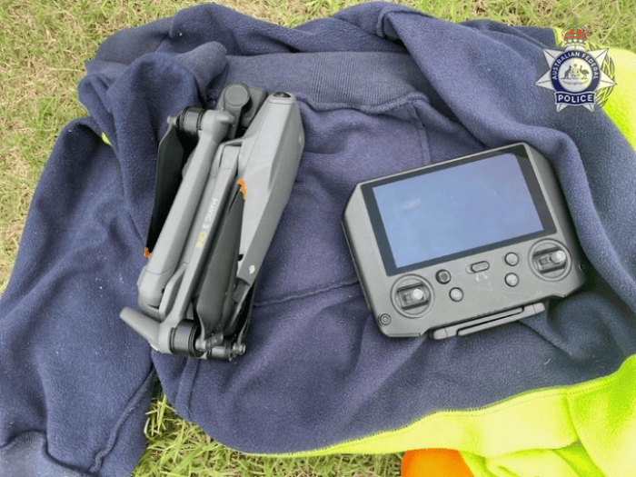 Drone and drone control placed on a jacket on the ground