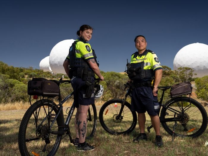 PSOs posing in front of bikes