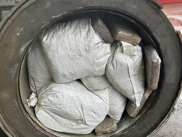 A generator cut open revealing bags of drugs inside
