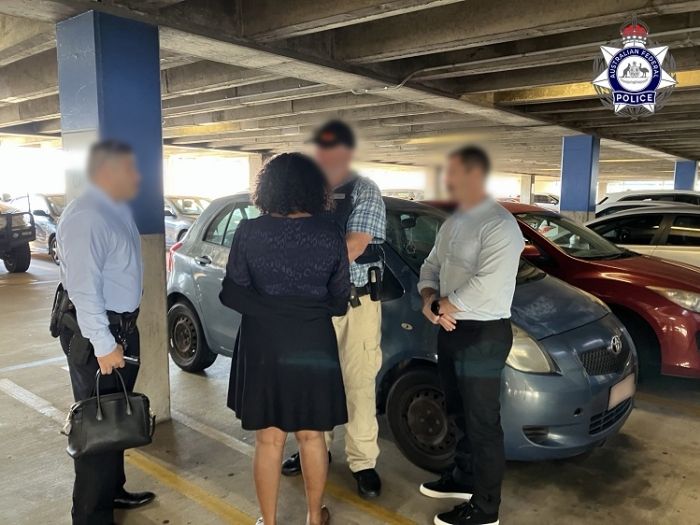 arrested woman with taskforce investigators
