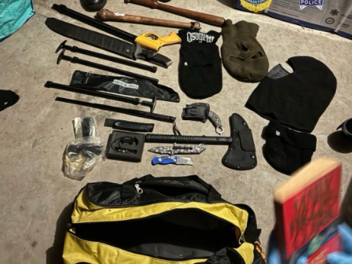 Photograph shows a number of assorted weapons on the ground
