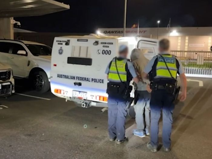 AFP escorting accused man under arrest.