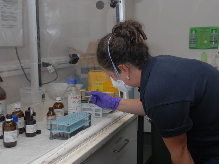 An AFP forensic scientist examines substances