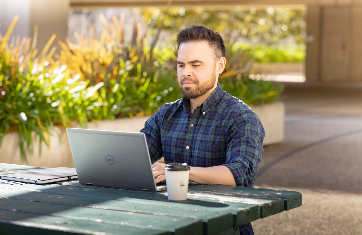 AFP suupport staff member sitting at desk with computer