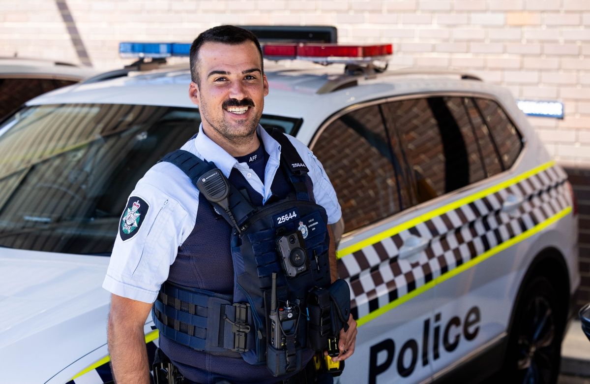 ACT Police Officer in front of an ACT Police car