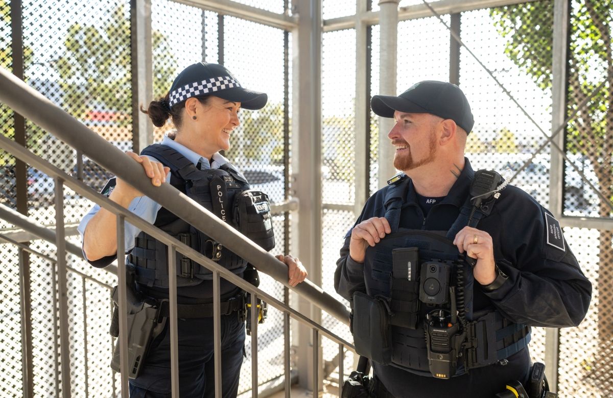 Two AFP officers in uniform talking in a stairwell