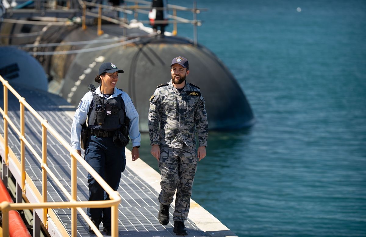 AFP Protective Service Officer and navel officer walking in front of submarine