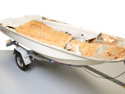 Fibreglass boat sliced open to reveal stacks of brown blocks