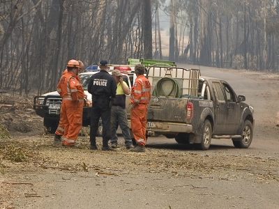 AFP Officer meets with SES personnel and Victorian resident as part of their deployment following the ‘Black Saturday’ Bushfires of 7 February 2009 (AFPM12890)