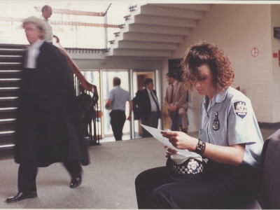 An AFP officer (in slacks) preparing to give evidence in the ACT Magistrates Court in 2001 (AFPMRN445)