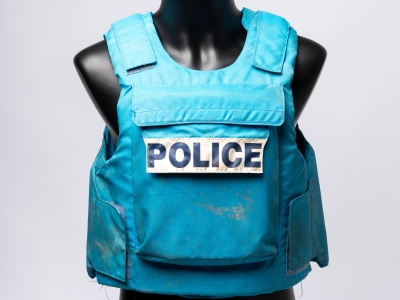 Blue woven fabric padded vest with front pocket and large white label that reads 'POLICE' in large black block letters (AFPM8869)