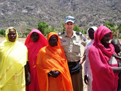 An Australian police peacekeeper with women and a child in Kurmuk, the Sudan. The Australian Federal Police provided officers to the United Nations Mission in the Sudan (UNMIS), between 2005 and 2007