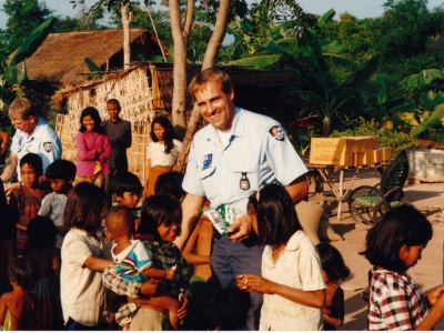 Australian police peacekeepers handing out lollies at a community engagement event in Cambodia, in 1992. Cambodians had few luxuries and struggled for food in a war-ravaged environment. 