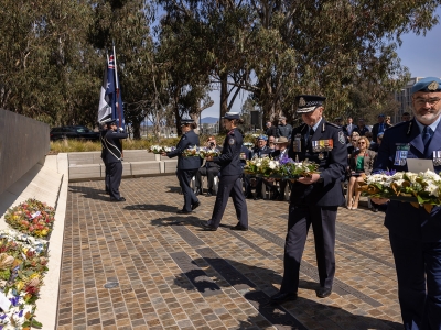 (Left to right) - Victoria Police, acting Assistant Commissioner Therese Fitzgerald, Northern Territory Police Assistant Commissioner Janelle Tonkin, AFP – ACT Policing Deputy Commissioner Scott Lee and NSW Police Superintendent Toby Lindsay, laying wreaths at the 60 Years of police peacekeeping memorial service at the National Peacekeepers Memorial.