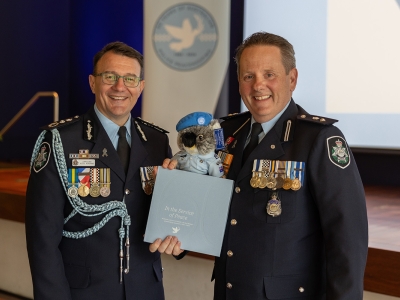 AFP Commissioner Reece P Kershaw, Superintendent Jason Byrnes with limited edition peacekeeping Kenny Koala bear launching 'In the Service of Peace' book at the 60 years of police peacekeeping lunch.